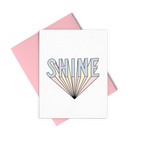 Shine greeting card is a bold graphic lettering and a pink envelope.
