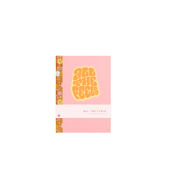 Cute pink notebook says All the Feels on the cover and has floral print binding on the spine. Shown wit point of sale bellyband.