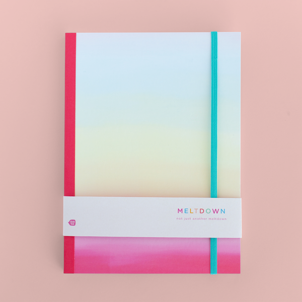 A rainbow ombre notebook with a hot pink spine.