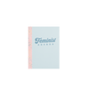 A small light blue notebook with Feminist Agenda written on the cover and a patterned pink binding