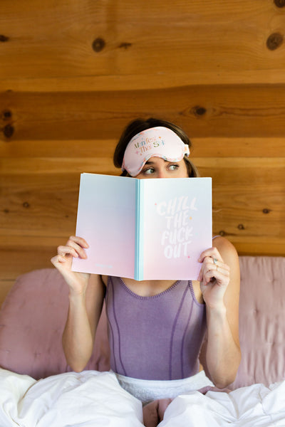 Women peeoping over an open notebook with  Blue to Pink Gradient with Chill The Fuck Out text in white