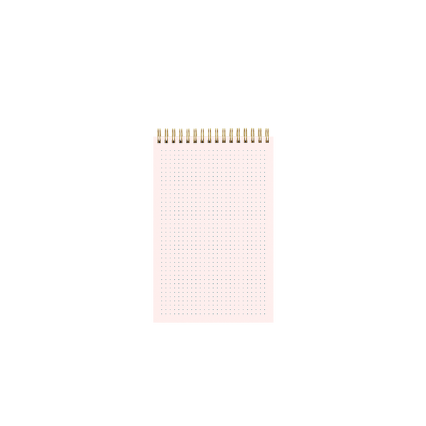 Inside page of a gold wire-bound pink taskpad showing a tiny dot grid pattern.