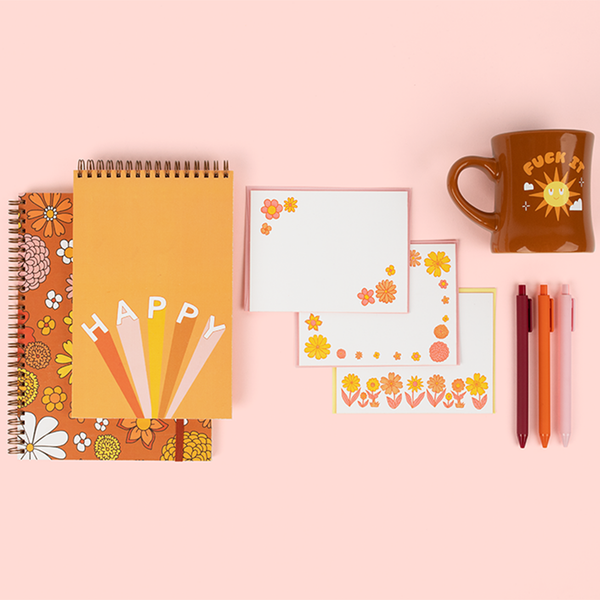 cute notebooks, a floral stationery set with pens and a mug