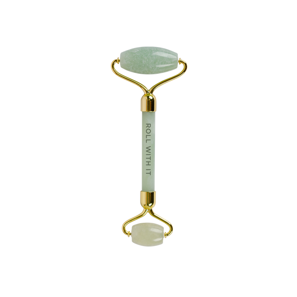 Jade and gold stone roller that says roll with it on the handle