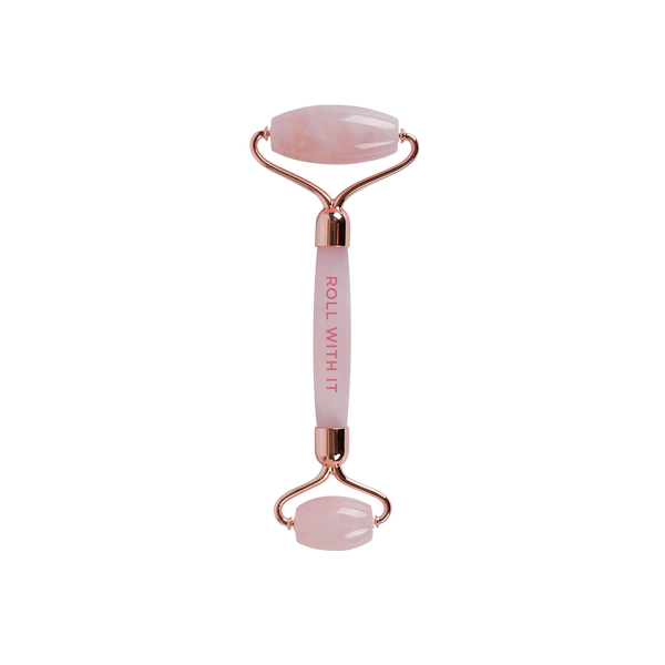 Pink and gold stone roller that says roll with it on the handle