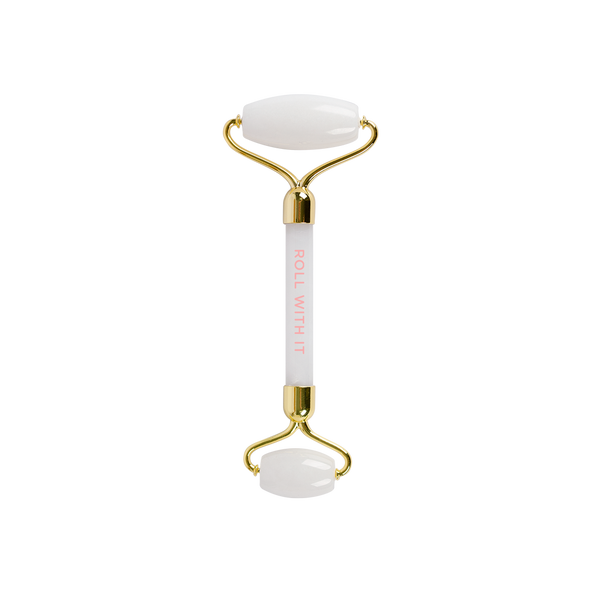 White and gold stone roller that says roll with it on the handle