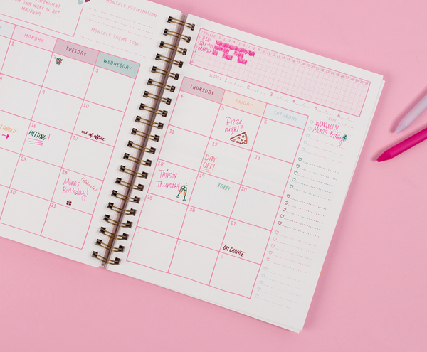 Planner with Pink Jotter pen writing.