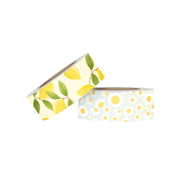 Two rolls of washi tape. The first is yellow with lemons and greenery. The second is an ombre background with white and yellow daisies. 