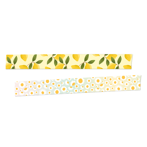 Two rolls of washi tape rolled out.  The first is yellow with lemons and greenery. The second is an ombre background with white and yellow daisies.