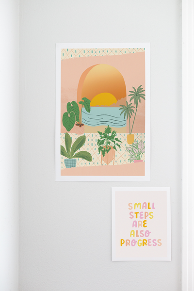 A print with window looking out at an ocean sunset. Before the window, different potter plants are on a cute floor. Print is multicolored and is hanging on a white wall along with a "Small Steps are also Progress" print hanging beneath it.