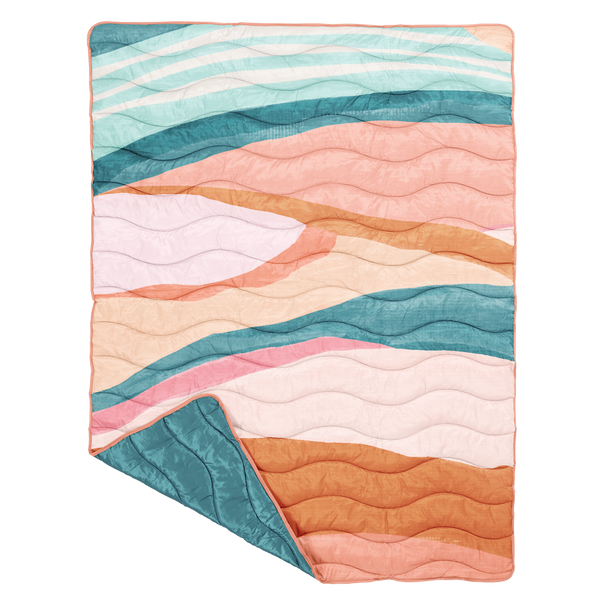 puffy quilted blanket in a pastel and teal swirl pattern with solid teal on the backside