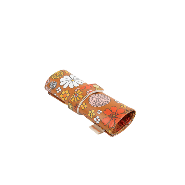 Small TOOTsie roll pouch in vegan leather in groovy brown floral pattern closed with strap and snap closure