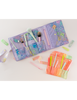 Large and small TOOTsie roll travel pouches open with fun prints and colors filled with makeup brushes and jotter pens