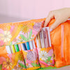 A cute, groovy flower pattern with rainbow swirls printed onto a roll-up back with four pockets, plus a side zip up pocket. Great for holding pens, cosmetic products and tools, and other small objects.