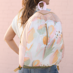 a ripstop backpack with an abstract leaf pattern over girls shoulder