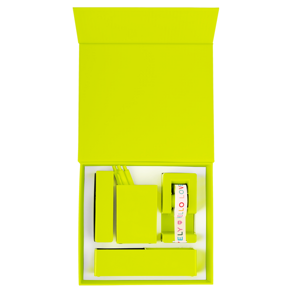 Overhead view of an opened citron desk set with a citron stapler, tray, tape dispenser, and pen cup with pens all nestled in a foam insert.