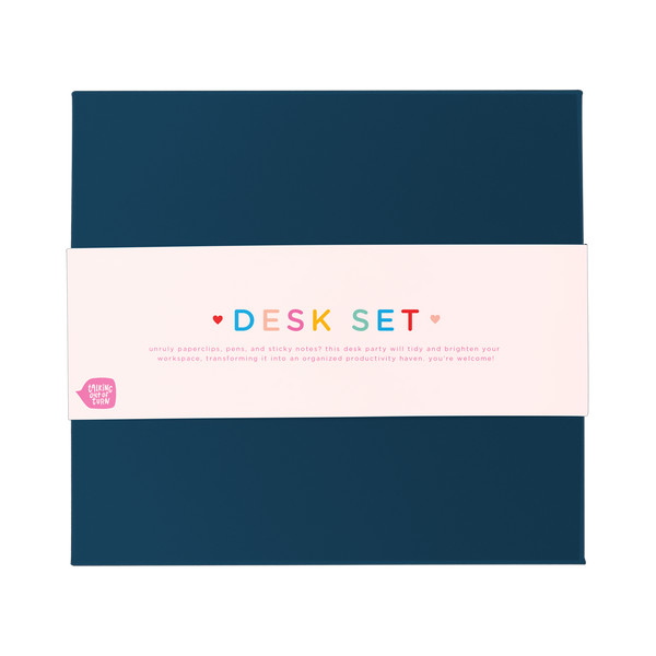 Top view of a closed navy desk set box with a cute packaging band wrapped around the middle.