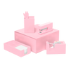 Blush Pink desk set including a stapler, tape dispenser, utility tray, and pen cup with three pink pens all stacked on top of a matching box.