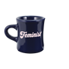 Navy blue diner funny coffee mug with Feminist written in pale pink hand lettered font. 