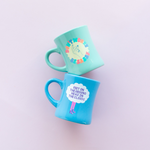 old school diner mugs in mint and blue which say dont worry be sassy and feet on the ground mugs