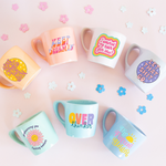 collection of coffee mugs with funny sayings with flower confetti