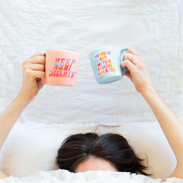 Peach mug which says keep dreamin'