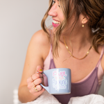 Brunette haired woman smiling and holding a Cornflower blue mug with funny saying of "lower your fucking voice"