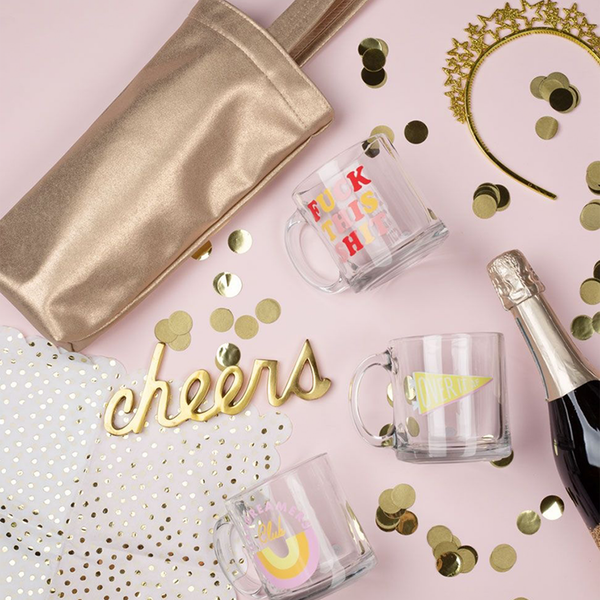 Cute party scene with funny coffee mugs, a cute wine tote, and champagne.