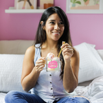 a girl holding a cute glass mug that says shit show in pink