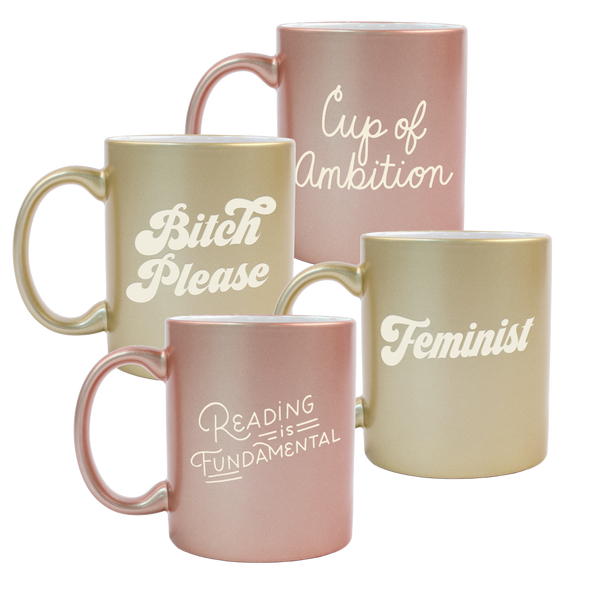 A mix of two gold and two rose gold funny coffee mugs with Bitch Please, Feminist, Reading Is Fundamental, and Cup Of Ambition engraved in hand-lettered fonts.