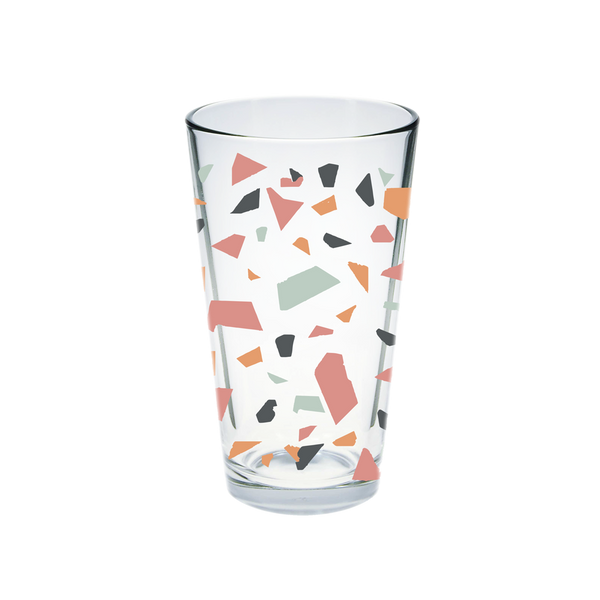 Clear glass pint glass with multi-colored terrazzo pattern.