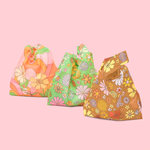 three cute flower printed tote bags sitting 