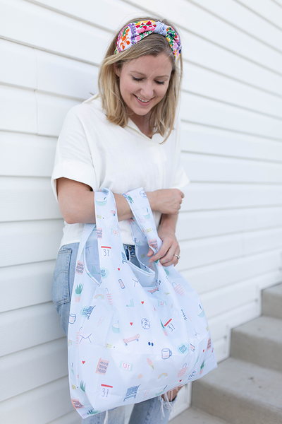 Twist and Shout Lucky Charms is a medium, cute reusable bag in light blue with illustrated charms pattern.