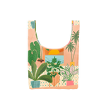 A costal scene out a window with potted plants surrounding the window on a medium reusable tote. 