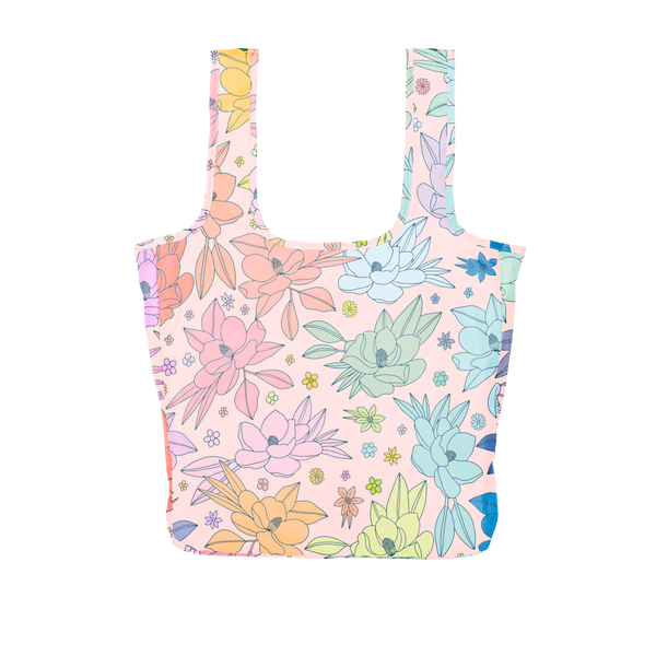 A large pink reusable tote with multi-colored magnolia flowers.