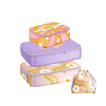 Packing cube set in different sizes and in the colors of purple, orange, pink, and green.. Wavy daisy design, a purple packing cube with "Who Cares" written in a pastel orange color. Tarot dreamer packing cube with and eye, rainbow, and starts around.