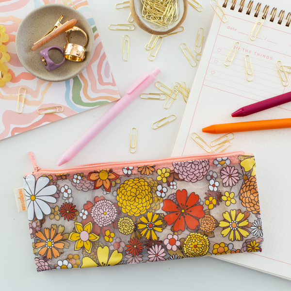 Cute pencil pouch clear plastic with floral print on top with peach zippers. Includes 3 Jotters in colors Blush Pink, Orange, and Luxardo.