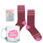 Shit Show kit including a glass coffee mug, sassy socks, and an enamel pin.