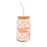 A 16 oz can glass with glass straw; pink checker print wrap around the glass. "Trust Your Vibes" is printed on the front in orange font, purple minimalist sparkle-stars surround the text.