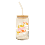 A 16 oz can glass with glass straw. "ZERO FUCKS GIVEN" is printed on the front in multi-color font; illustrations of a cloud, rainbow, and sun surround the text.