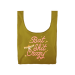 olive green compact reusable tote bag with pink lettering saying "Bat shit crazy" with yellow to white ombre bat with sparkle stars. 