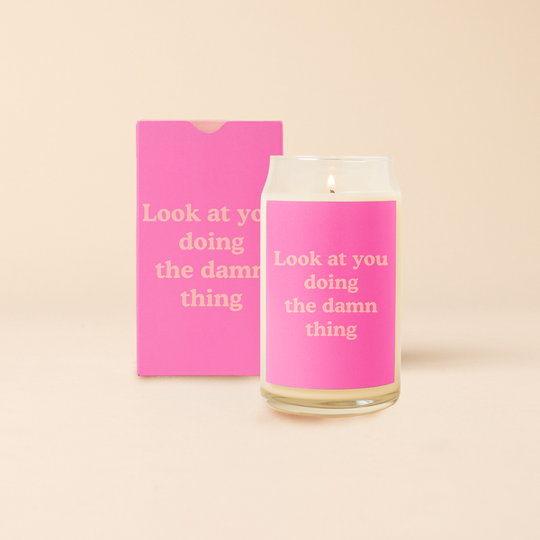 16 oz candle can glass with pink decal and text that reads "Look at you doing the damn thing" in coral font. Pink box with same design sits behind candle.