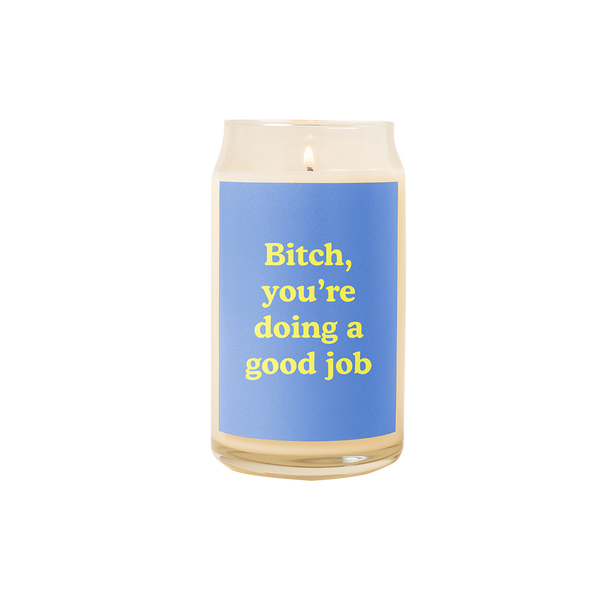 A 16 oz. candle with a blue decal on it with the phrase "Bitch, you're doing a good job" printed on.