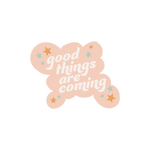 "good things are coming" sticker with a peach background and blue and mustard yellow stars.