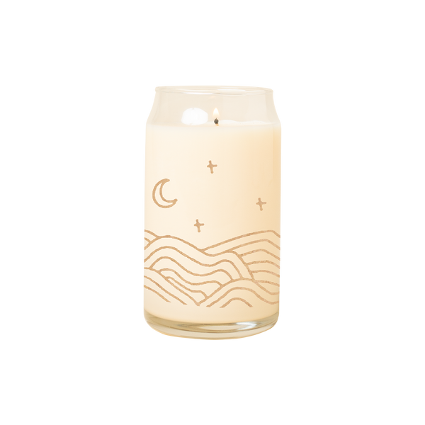 A 16 oz. candle with abstract "Chill Hills" printed all around the lower part of the candle glass. Design is in gold coloring and also has a moon and stars printed above the hills.