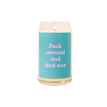 A 16 oz. candle with a teal decal on it with the phrase "Fuck around and find out