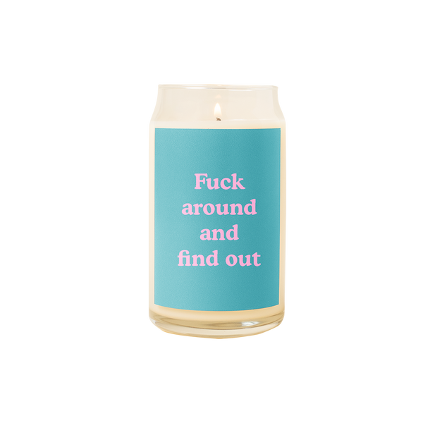 A 16 oz. candle with a teal decal on it with the phrase "Fuck around and find out