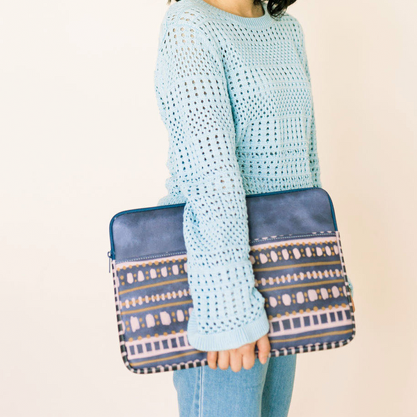 Girl in a blue sweater holding a cute laptop sleeve in Boho Dress pattern.