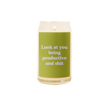 A 16 oz. candle with a green decal on it with the phrase "Look at you being productive and shit" printed on.
