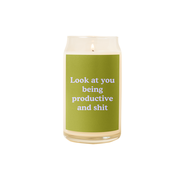 A 16 oz. candle with a green decal on it with the phrase "Look at you being productive and shit" printed on.
